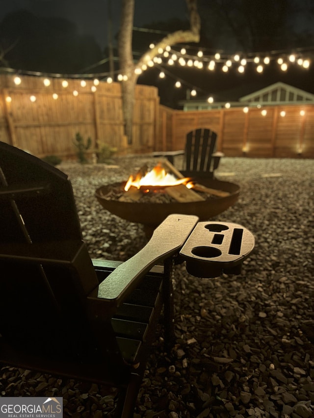 patio at night featuring a fire pit