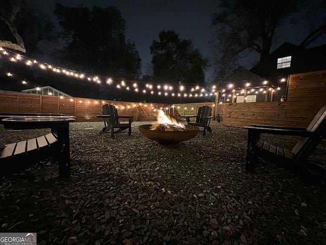 patio at twilight featuring an outdoor fire pit