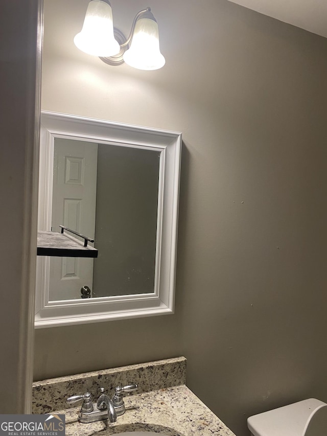 bathroom with toilet and vanity