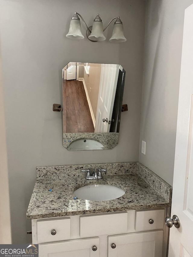 bathroom with wood finished floors and vanity