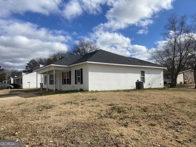 view of side of property with a yard