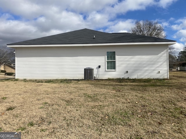 view of home's exterior featuring cooling unit and a yard