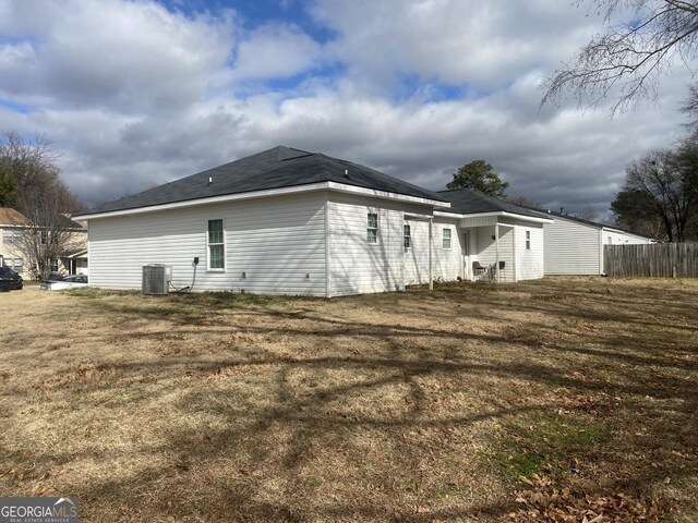 view of side of home featuring a yard and central air condition unit