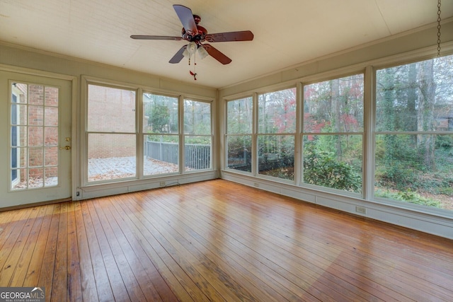 basement with carpet, a paneled ceiling, and wooden walls