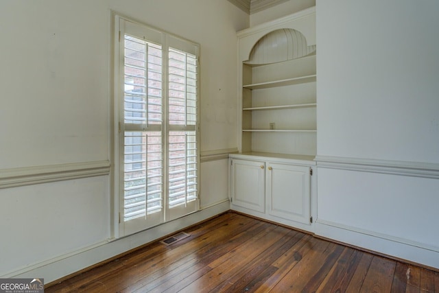 staircase with built in shelves, wood-type flooring, and ornamental molding