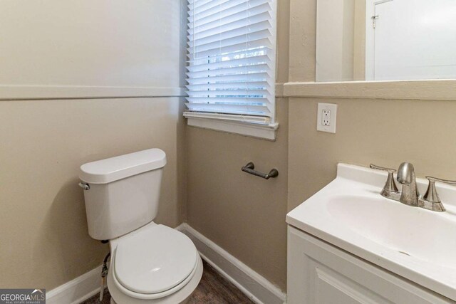 bathroom featuring vanity, hardwood / wood-style flooring, and toilet