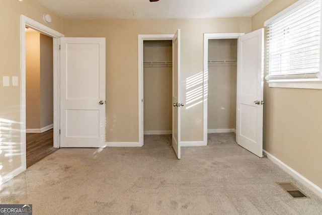 unfurnished bedroom with light colored carpet