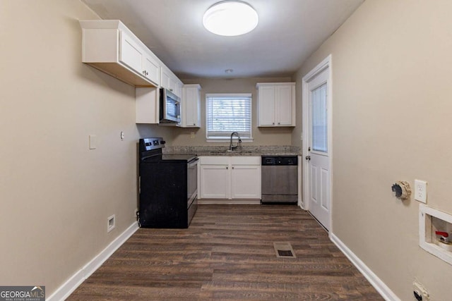 kitchen with white cabinetry, sink, dark hardwood / wood-style floors, and appliances with stainless steel finishes