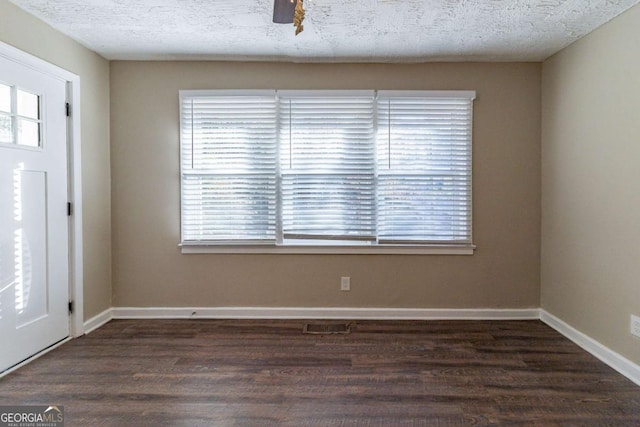 foyer featuring a textured ceiling and dark hardwood / wood-style floors