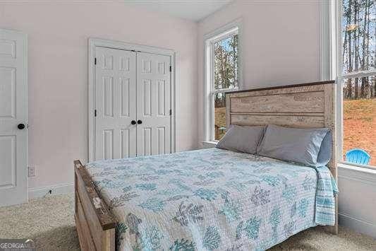 bedroom with a closet and baseboards