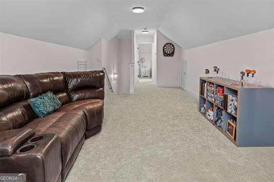 carpeted living room featuring lofted ceiling