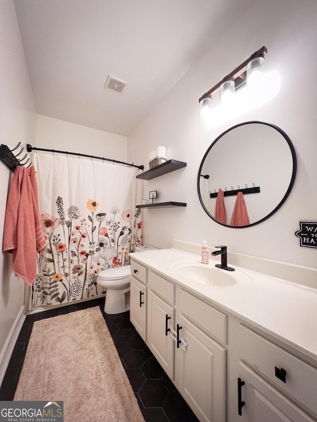 bathroom featuring vanity and toilet