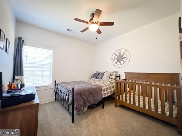 bedroom with ceiling fan and carpet floors