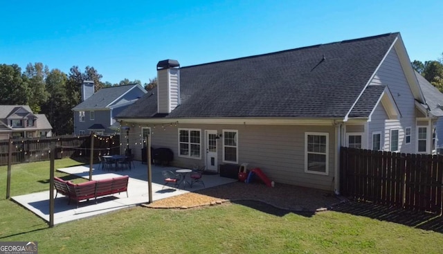 back of property featuring a lawn and a patio area