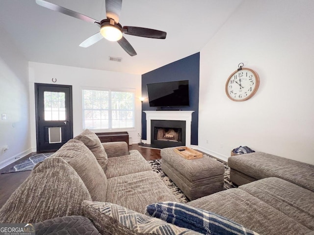 living room with dark hardwood / wood-style floors, vaulted ceiling, and ceiling fan