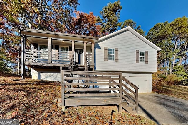 view of front of property featuring covered porch and a garage