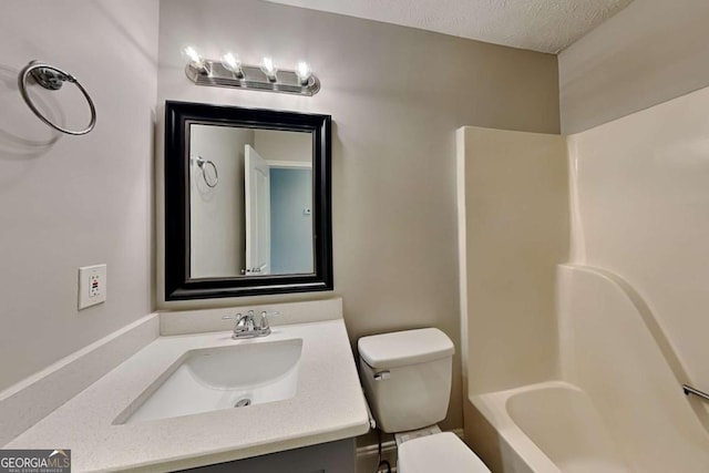 full bathroom featuring vanity, a textured ceiling, bathing tub / shower combination, and toilet