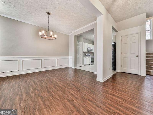 interior space featuring a chandelier, hardwood / wood-style floors, a textured ceiling, and crown molding