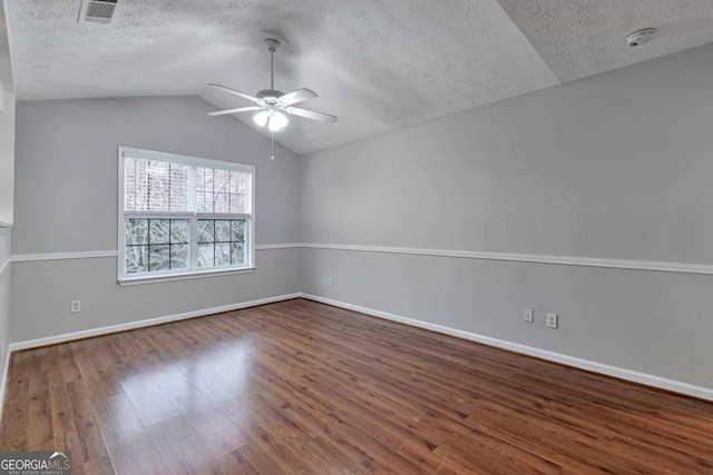 spare room with lofted ceiling, ceiling fan, a textured ceiling, and hardwood / wood-style flooring