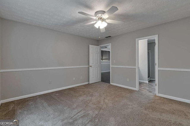 unfurnished bedroom featuring carpet, ceiling fan, and a textured ceiling