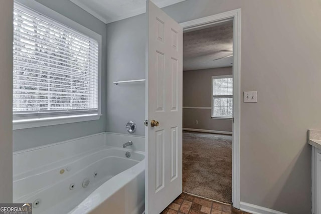 bathroom with vanity, a textured ceiling, and a tub to relax in