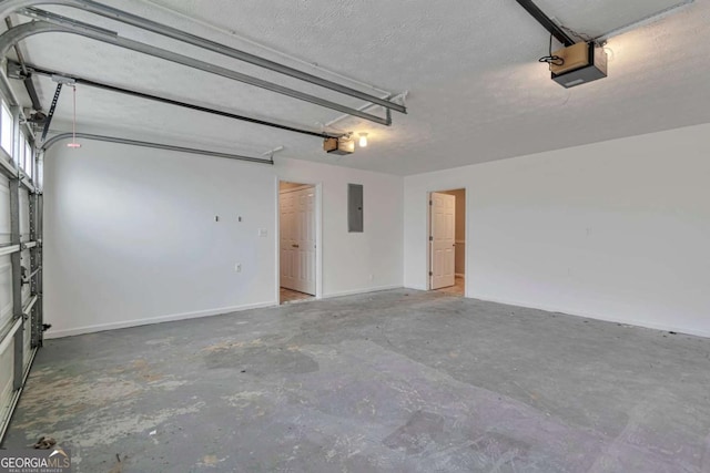 garage featuring electric panel and a garage door opener