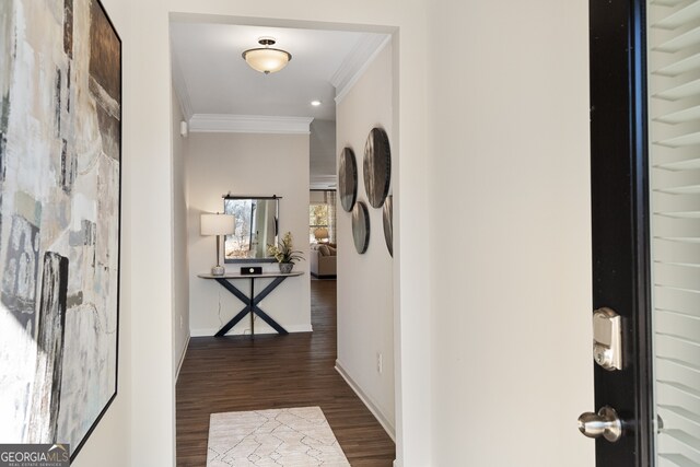 corridor with dark hardwood / wood-style floors and ornamental molding