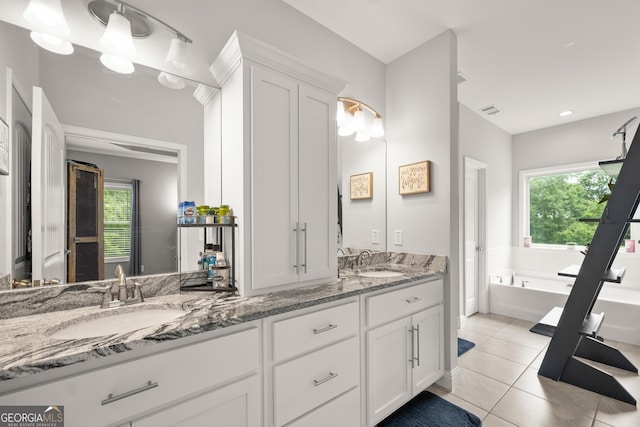 bathroom with vanity, tile patterned floors, a bathtub, and plenty of natural light