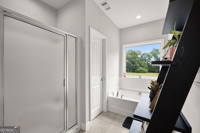 bathroom with tile patterned floors and separate shower and tub