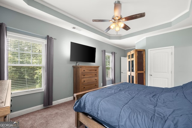 bedroom with carpet, ceiling fan, crown molding, and multiple windows