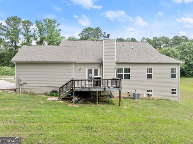 rear view of house featuring a lawn, cooling unit, and a wooden deck