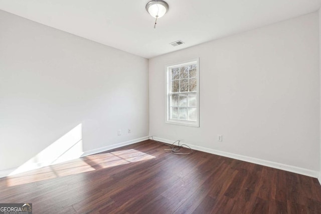 spare room with wood-type flooring