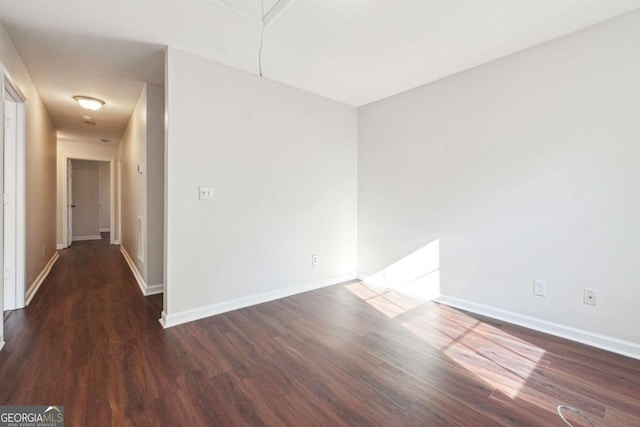 spare room with dark wood-type flooring