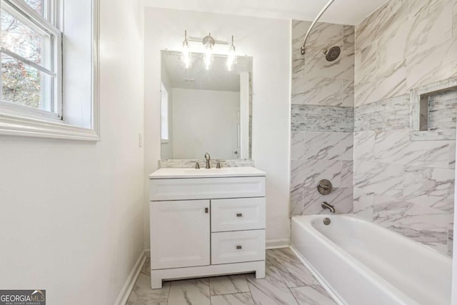 bathroom with vanity and tiled shower / bath combo