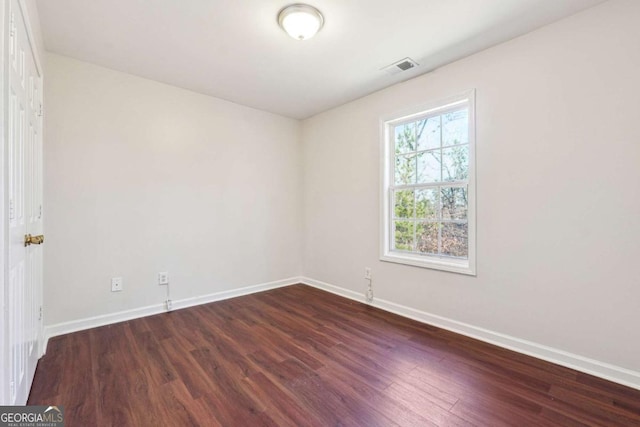 empty room featuring dark hardwood / wood-style flooring