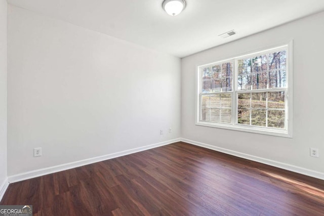 empty room with dark hardwood / wood-style floors