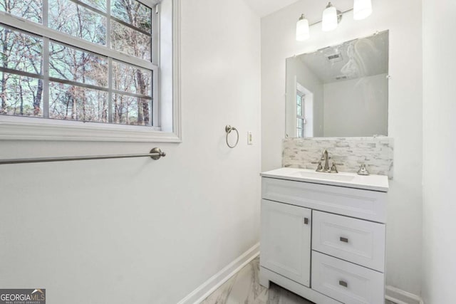 bathroom with vanity, backsplash, and a wealth of natural light