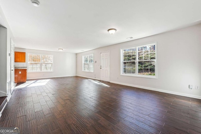 unfurnished living room featuring dark wood-type flooring