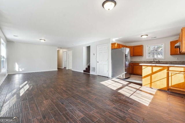 kitchen featuring stainless steel refrigerator with ice dispenser, light wood-type flooring, and sink