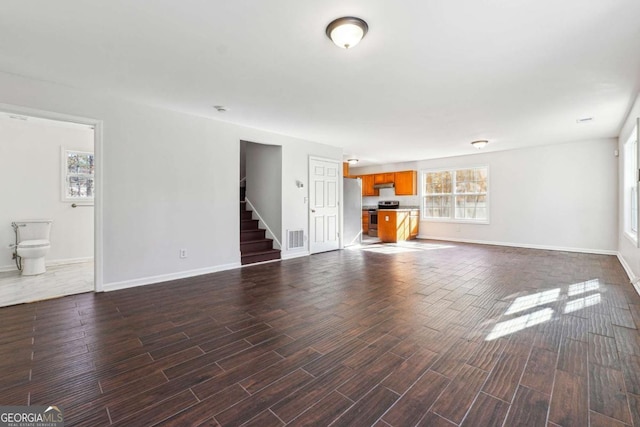 unfurnished living room with dark hardwood / wood-style flooring