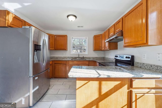 kitchen with light tile patterned floors, kitchen peninsula, sink, and appliances with stainless steel finishes