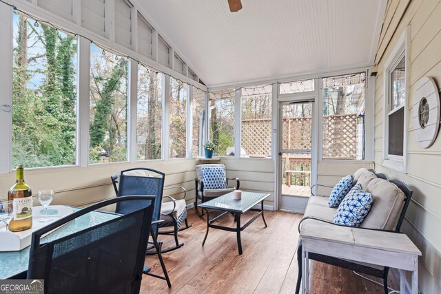 sunroom featuring a wealth of natural light and lofted ceiling