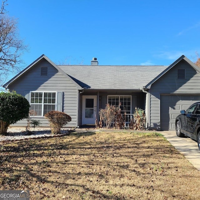 ranch-style home featuring a front yard and a garage