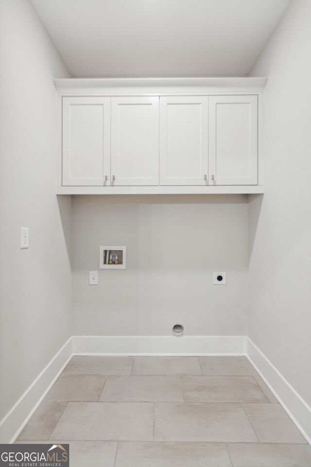 kitchen with hanging light fixtures, white cabinets, a center island with sink, and ornamental molding