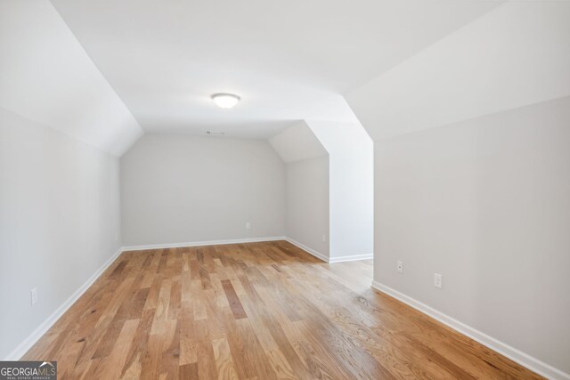 spare room with wood-type flooring and plenty of natural light