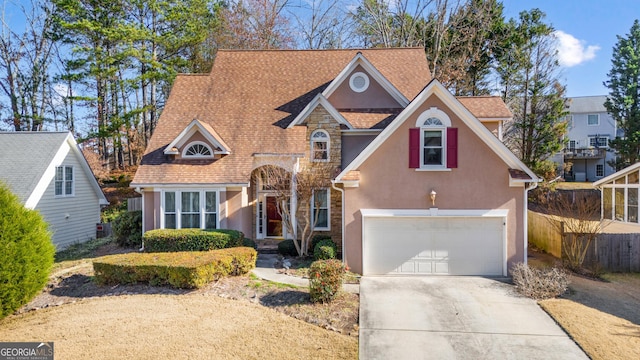 view of front of home with a garage and cooling unit