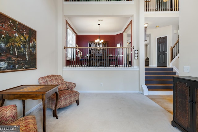 living area with a high ceiling, light carpet, and a notable chandelier