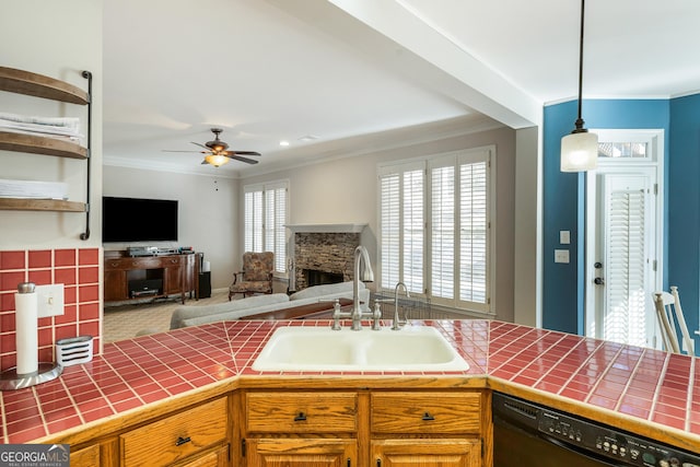 kitchen featuring tile countertops, black dishwasher, sink, hanging light fixtures, and crown molding