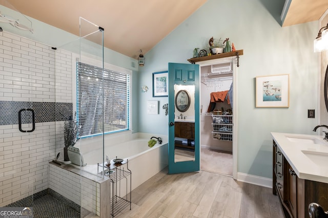 bathroom with lofted ceiling, hardwood / wood-style floors, vanity, and independent shower and bath