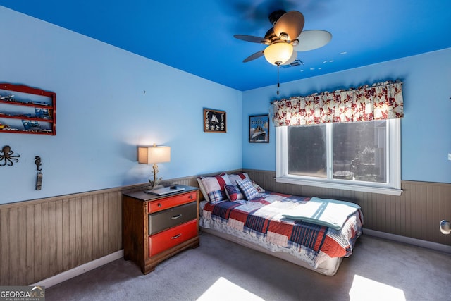 carpeted bedroom with wooden walls